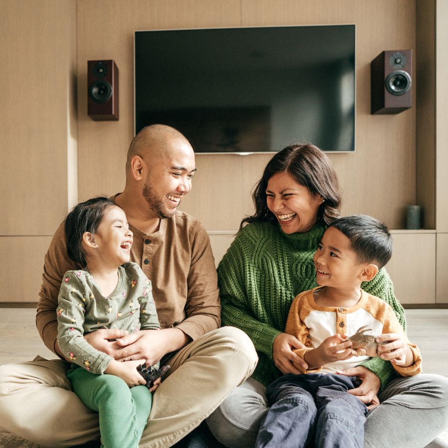 happy family sitting in living room 