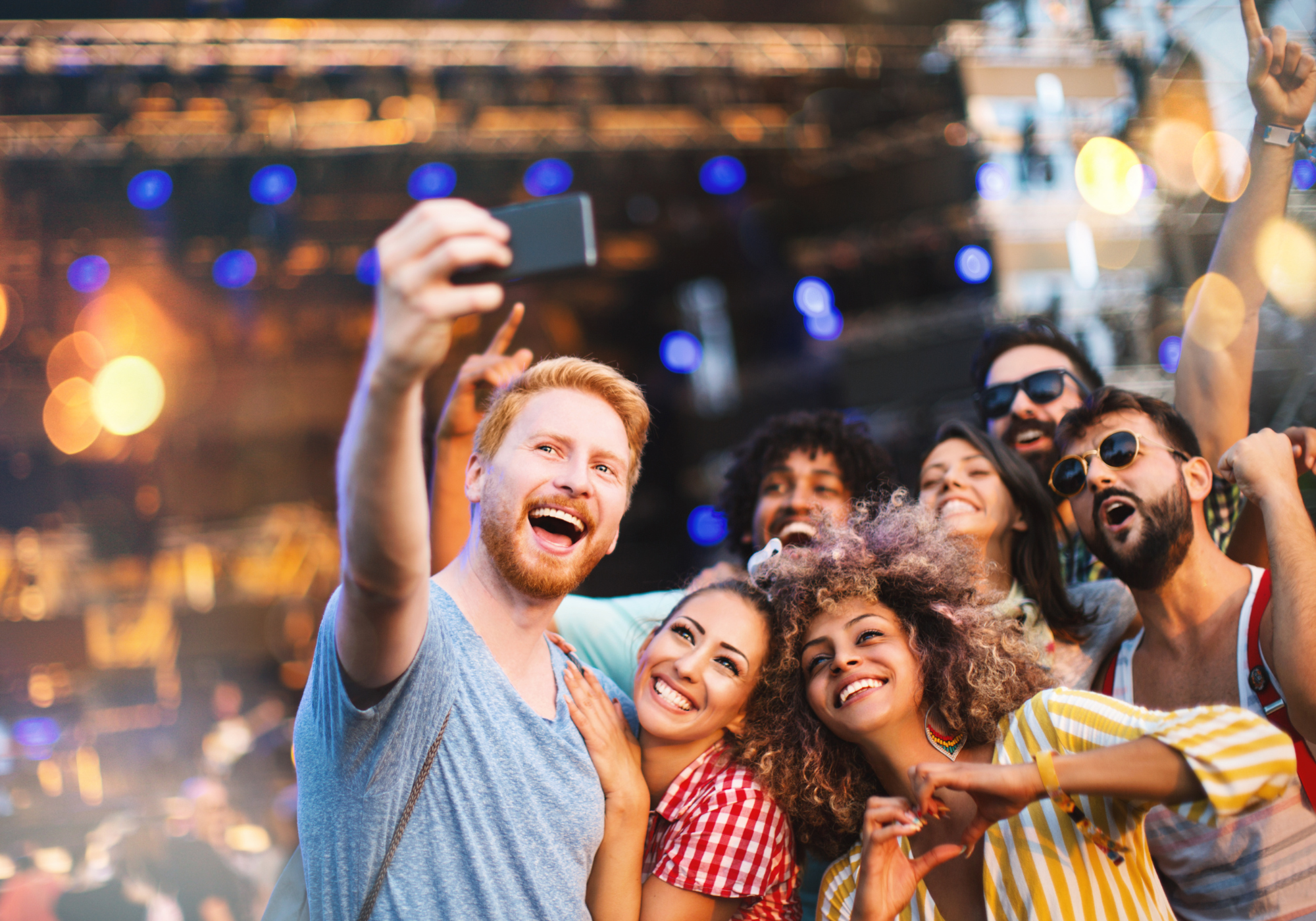 Friends gathered for a photo while enjoying a live performance.